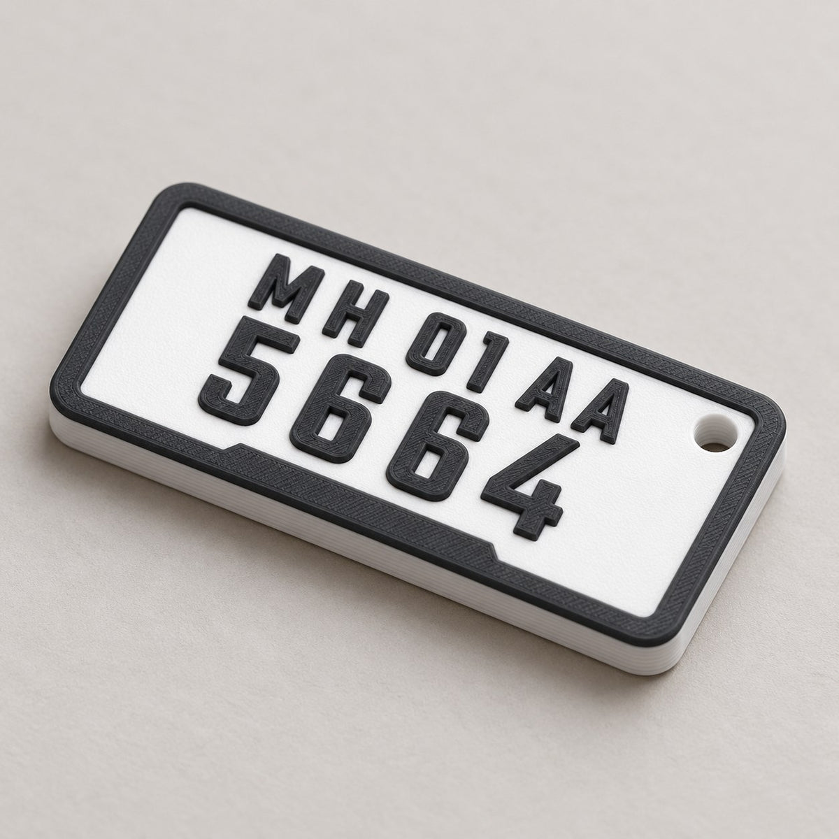 Number Plate Keychain: white 'MH 01 AA / 5664' plate keychain alone at a three-quarter angle