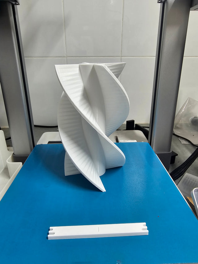 The finished antenna support printed in white PETG on the printer bed