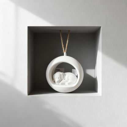 sleeping puppy ornament hanging in a cavity