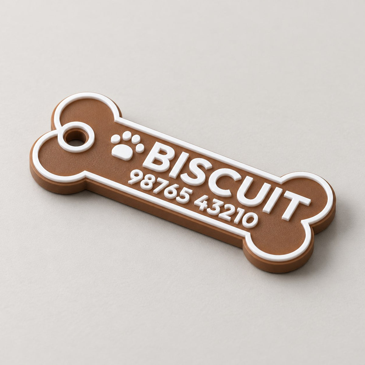 Bone Pet ID Tag: brown 'BISCUIT' bone tag alone at a three-quarter angle