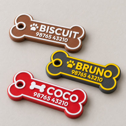 Bone Pet ID Tag: three bone tags (BISCUIT, BRUNO, COCO) laid flat, top-down at a slight angle