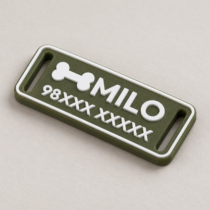 Silent Pet ID Tag: green 'MILO' tag alone lying flat at a three-quarter angle