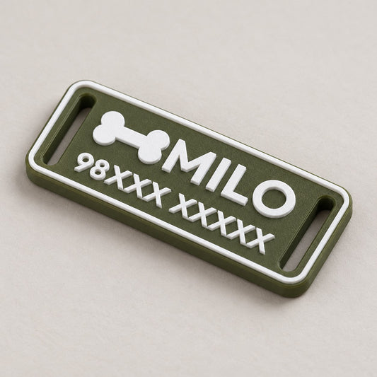 Silent Pet ID Tag: green 'MILO' tag alone lying flat at a three-quarter angle