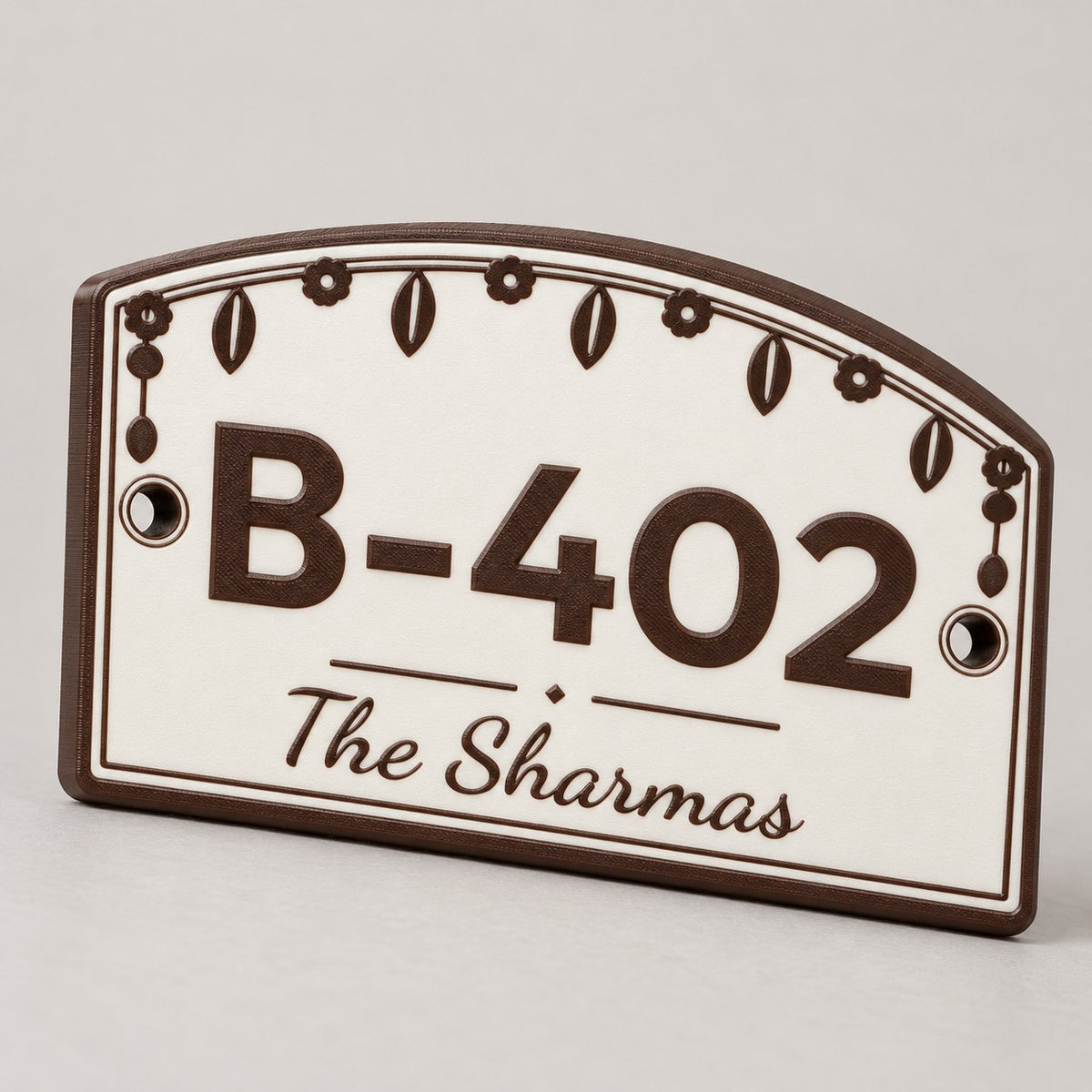 House Number Plate with Family Name: brown 'B-402 The Sharmas' plate alone, standing at a slight three-quarter angle