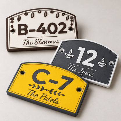 House Number Plate with Family Name: three plates (B-402 The Sharmas, 12 The Iyers, C-7 The Patels) arranged overlapping, front view