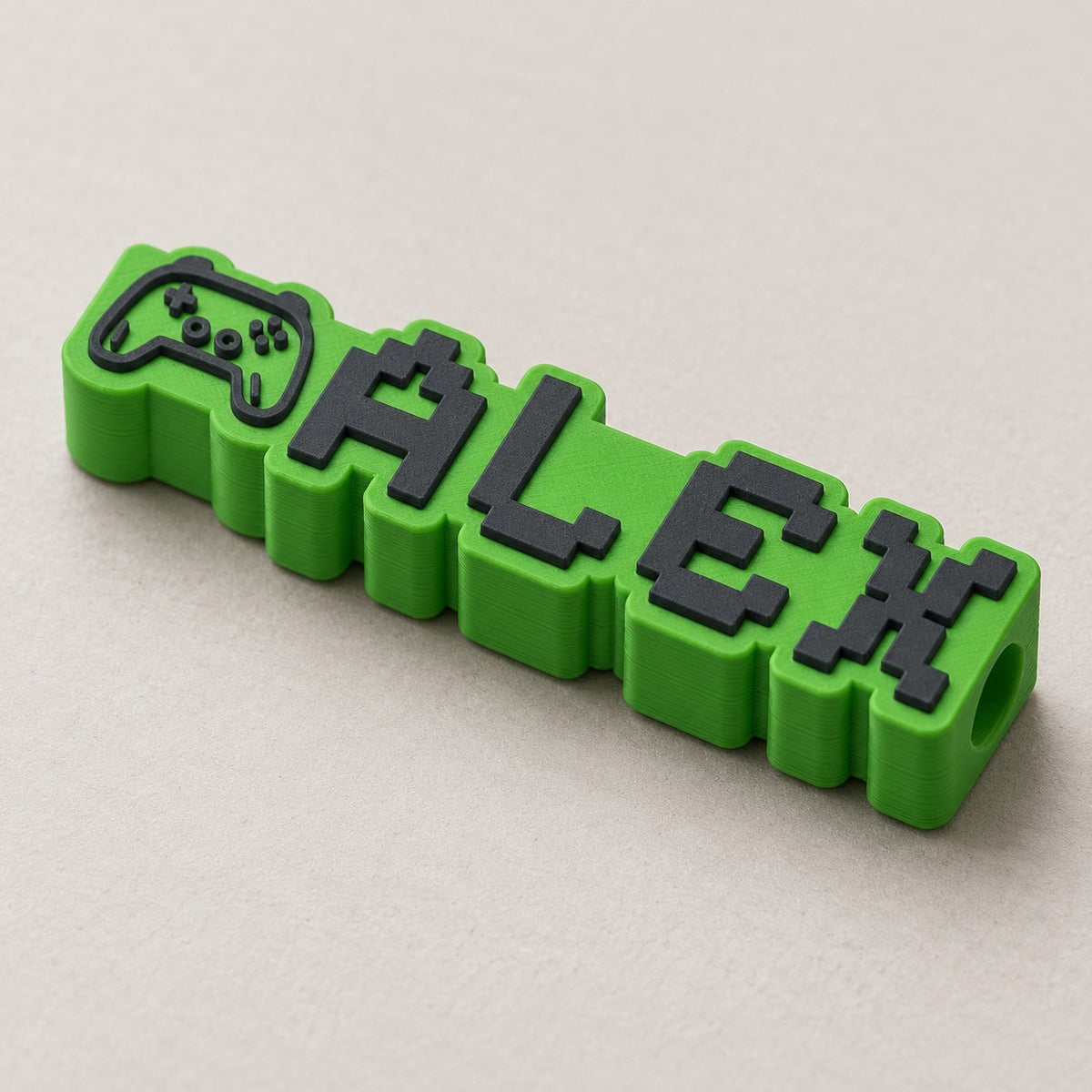 Gamer Name Pencil Topper: green 'ALEX' topper alone at a three-quarter angle