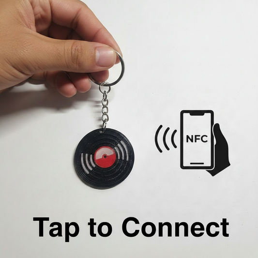 Person holding Smart NFC Vinyl Record Keychain with Tap to Connect NFC logo