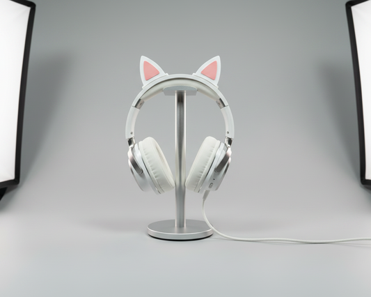 Cat ear clips on white headphone on stand - light grey studio background - 3:2