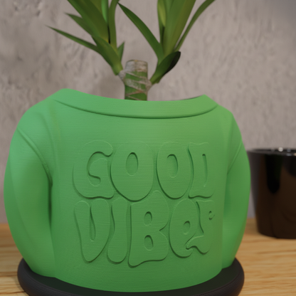 Close-up of Good Vibes embossed text on green 3D printed planter