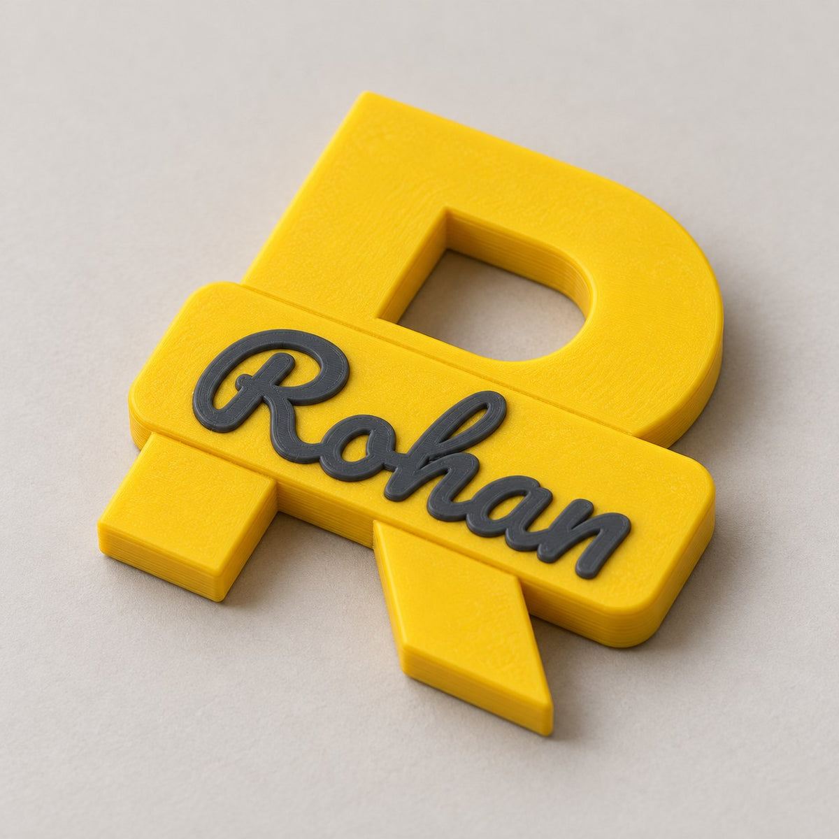 Personalised Initial Fridge Magnet: yellow R 'Rohan' magnet alone lying flat at a three-quarter angle