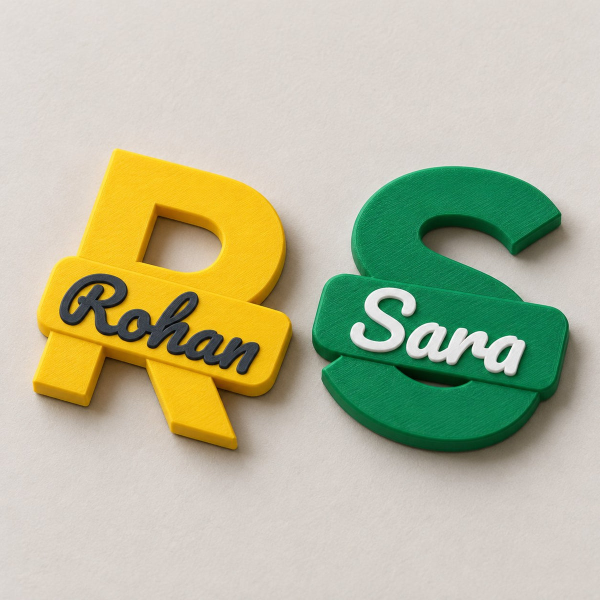 Personalised Initial Fridge Magnet: yellow R Rohan and green S Sara magnets lying flat side by side, top-down