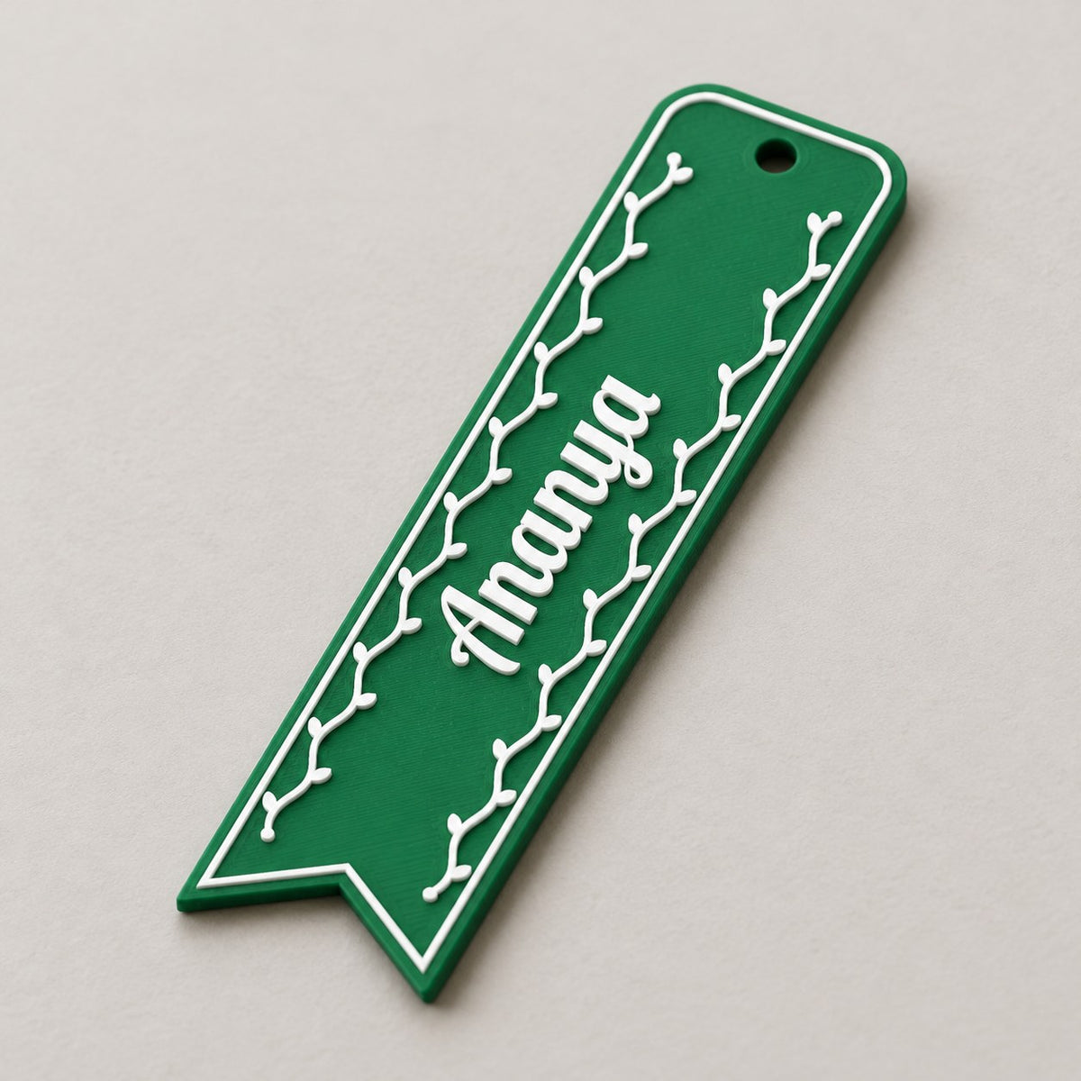 Name Bookmark: green 'Ananya' bookmark alone, lying at a slight diagonal, three-quarter view