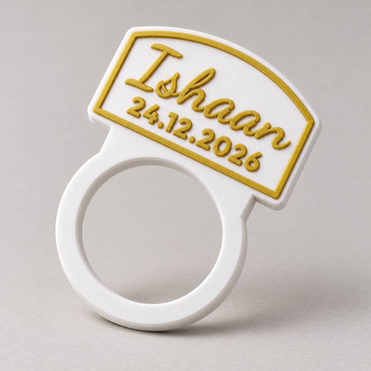 Personalised Napkin Ring: white 'Ishaan' napkin ring standing upright alone at a three-quarter angle, empty