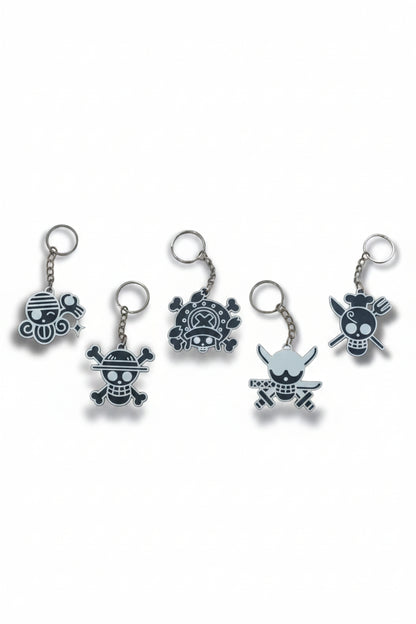 Set of five keychains with skull and crossbones designs on a white background