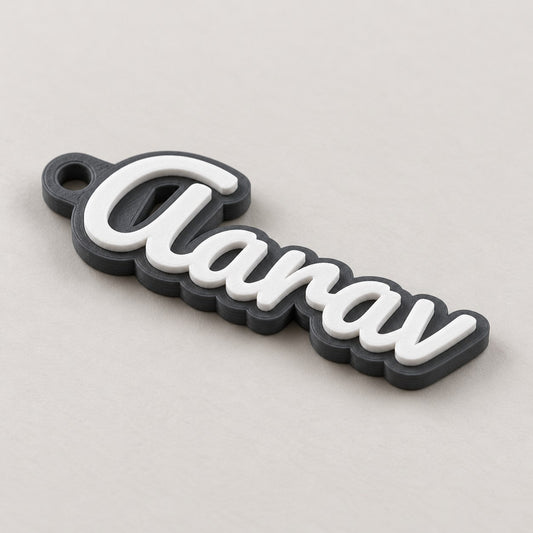 Personalised Name Keychain: dark grey 'Aarav' keychain alone at a three-quarter angle