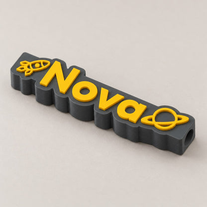 Space Name Pencil Topper: dark grey 'Nova' space topper alone at a three-quarter angle