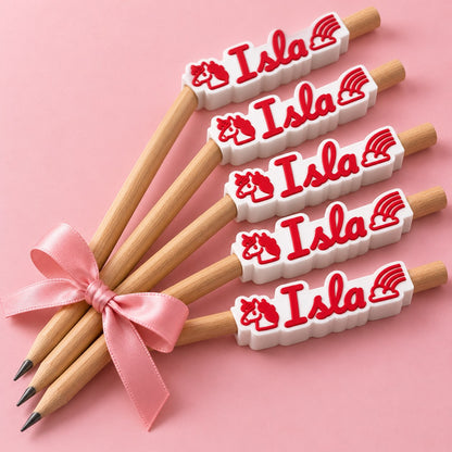Unicorn Name Pencil Topper: a bundle of five identical 'Isla' toppers on pencils tied with a ribbon as a birthday return gift, on a pastel table