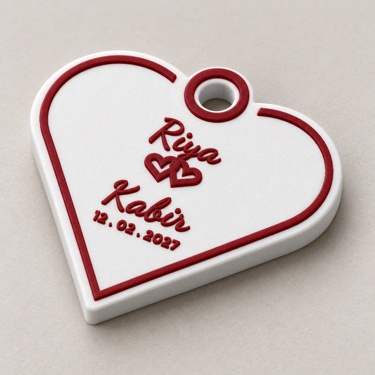 Wedding Favour Keychain: one heart-shaped Riya and Kabir keychain alone at a three-quarter angle